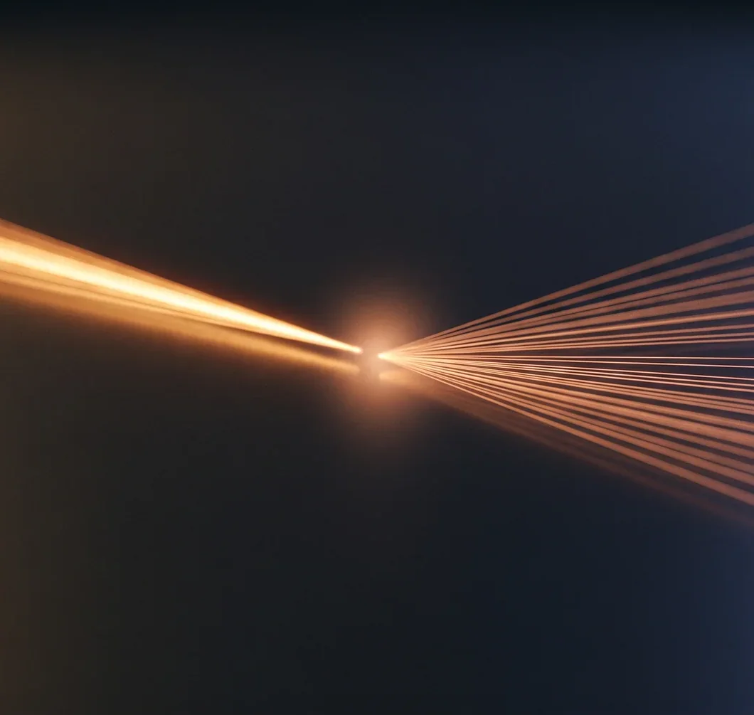 A single bright amber beam entering from the left and fanning out into dozens of thin rays across a dark blue-grey background.